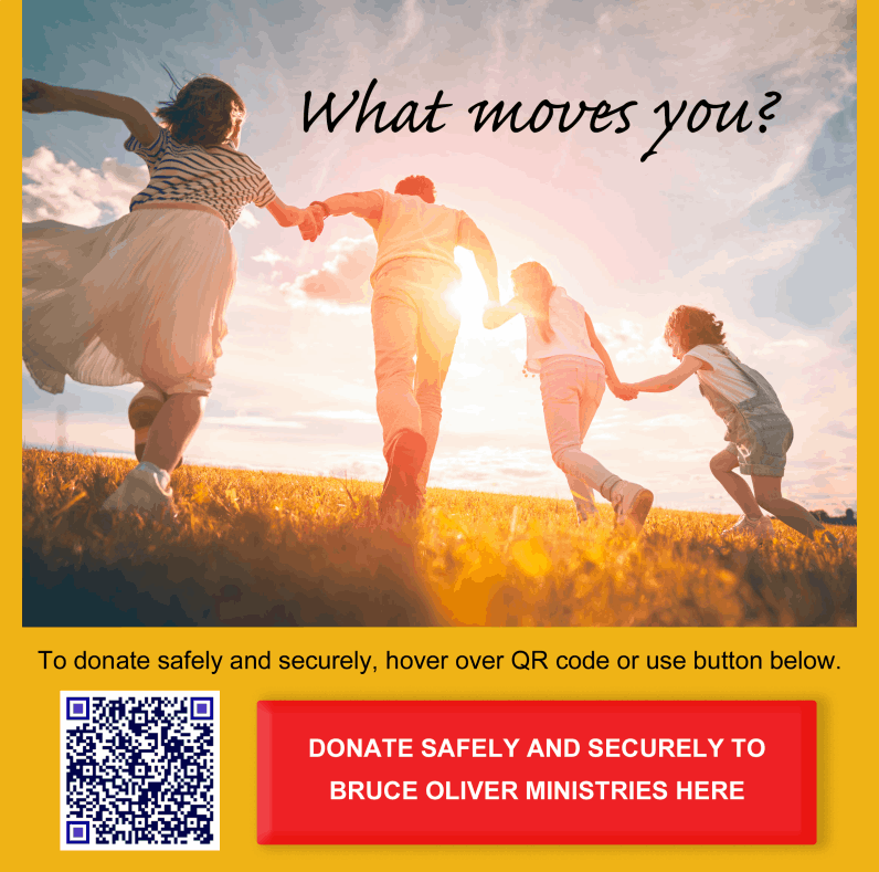 Family holding hands running through grass in sunlight